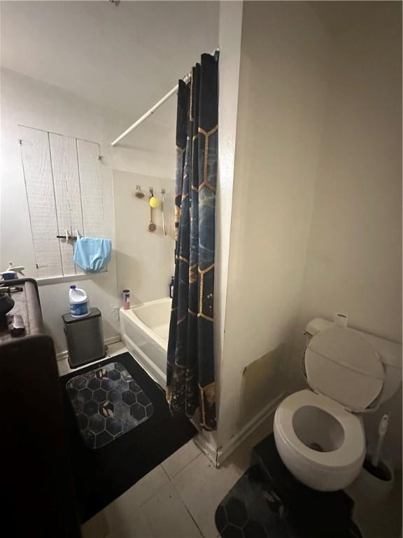 bathroom featuring toilet and tile patterned floors