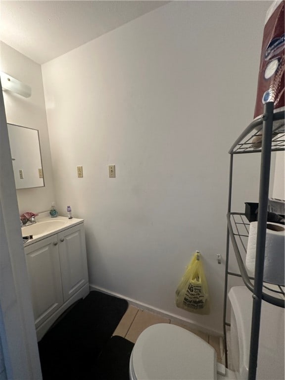 bathroom with vanity, tile patterned floors, and toilet