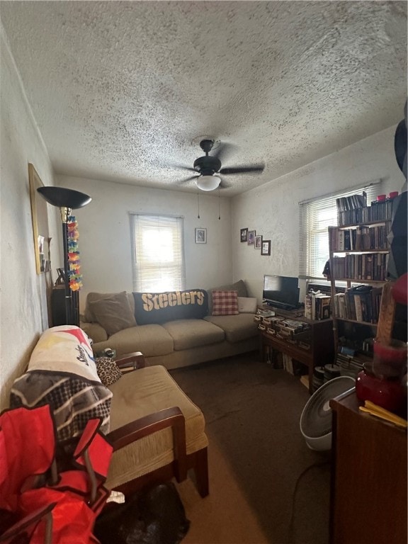 living room with carpet, a textured ceiling, and ceiling fan