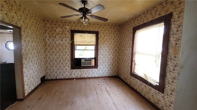 spare room with hardwood / wood-style flooring, cooling unit, and ceiling fan