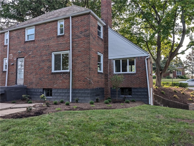 view of home's exterior with a lawn