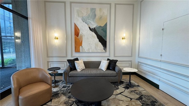 112 Washington Pl Unit 7E, Downtown Pgh, PA 15219 - living area featuring wood finished floors and a decorative wall