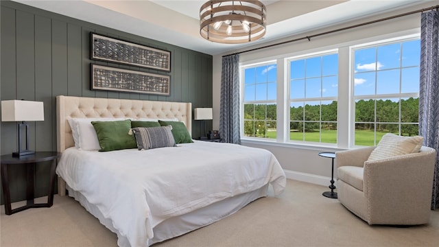 carpeted bedroom featuring an inviting chandelier