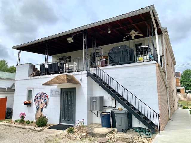 view of front of home featuring a balcony, cooling unit, and ceiling fan