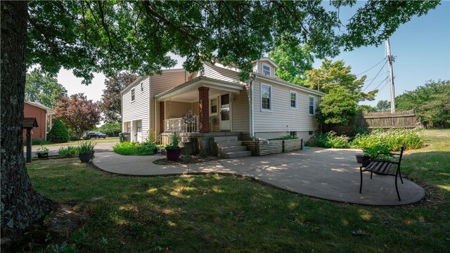 back of property with a lawn