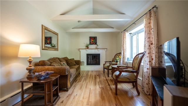 living room featuring vaulted ceiling with beams, a baseboard radiator, light wood-type flooring, and a brick fireplace