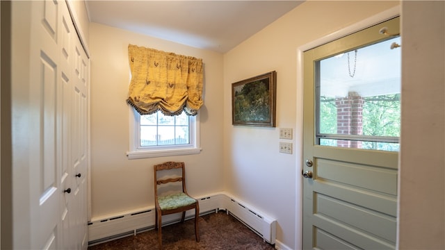 entryway featuring dark carpet and baseboard heating