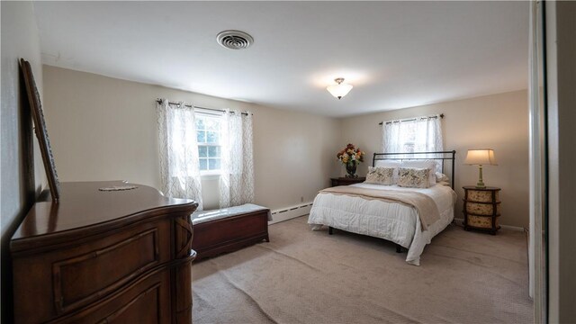 carpeted bedroom featuring multiple windows and baseboard heating