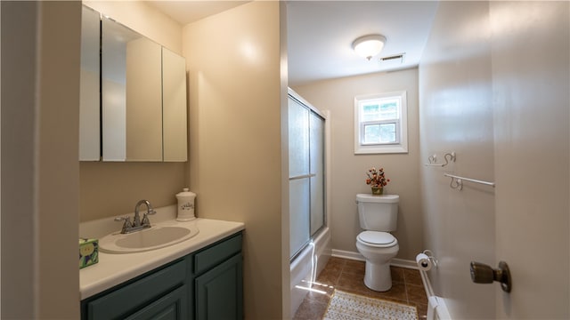 full bathroom with tile patterned flooring, toilet, enclosed tub / shower combo, and vanity