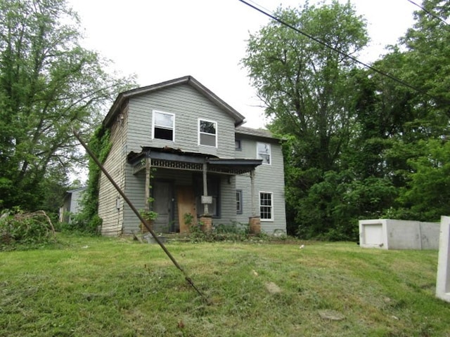 back of property featuring a yard