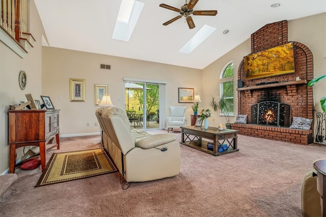 carpeted living room with ceiling fan, high vaulted ceiling, and a fireplace