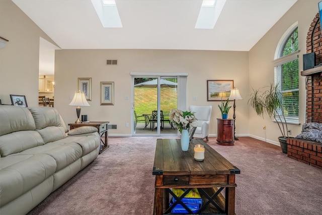 carpeted living room featuring lofted ceiling with skylight and plenty of natural light