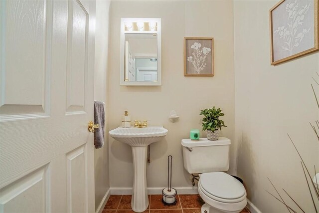 bathroom featuring toilet and tile patterned floors