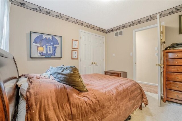 bedroom with a closet and light colored carpet