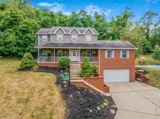 view of front of home featuring a front yard, covered porch, and a garage