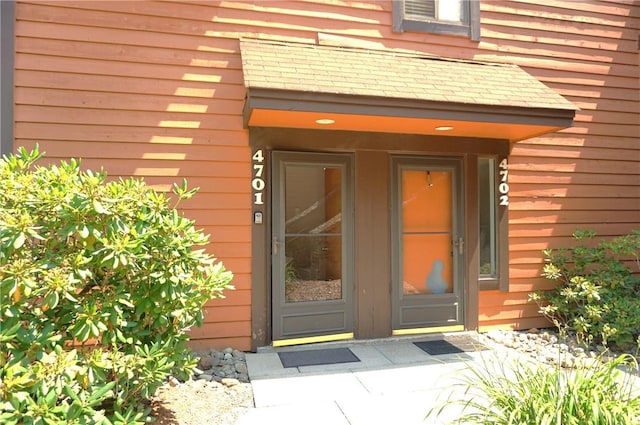 property entrance featuring brick siding