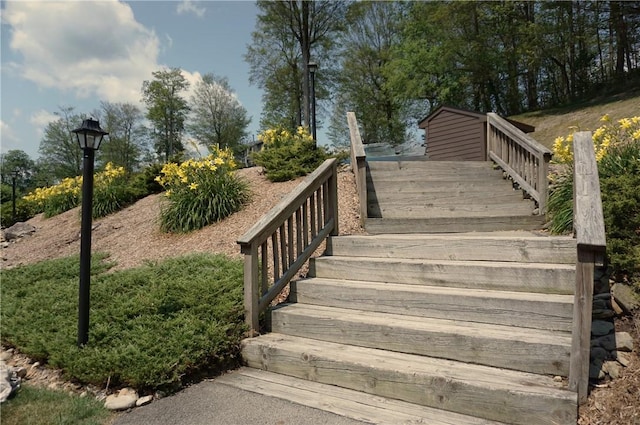 view of home's community featuring a deck and stairway