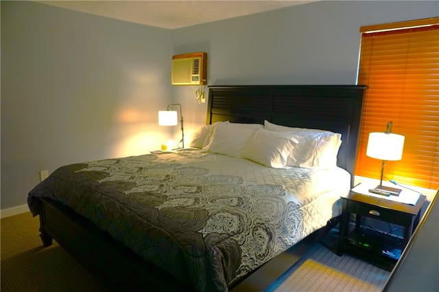 carpeted bedroom with a wall mounted air conditioner and baseboards