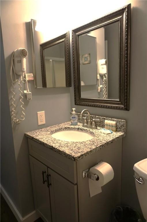 bathroom featuring toilet and vanity