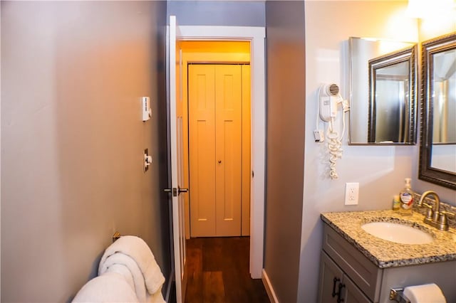 half bathroom with wood finished floors and vanity