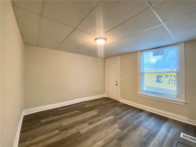 unfurnished room featuring a drop ceiling and hardwood / wood-style floors