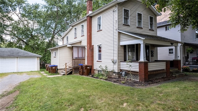 exterior space with a garage, an outbuilding, and a yard