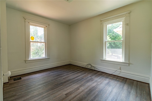 unfurnished room featuring hardwood / wood-style floors and a wealth of natural light