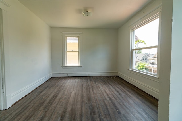 empty room with dark wood-type flooring