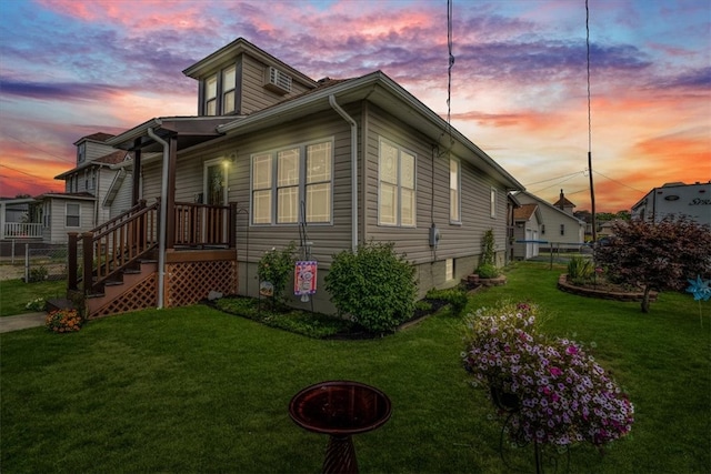 property exterior at dusk with a lawn