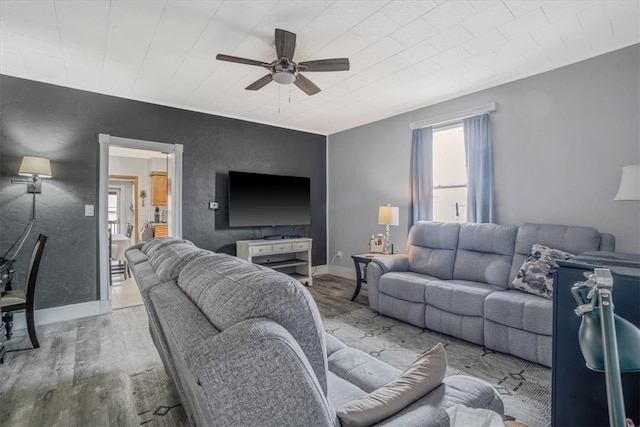 living room with light wood-type flooring and ceiling fan