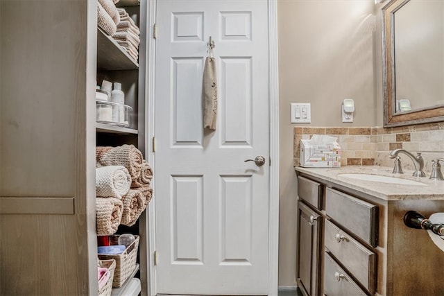 interior space with vanity and tasteful backsplash