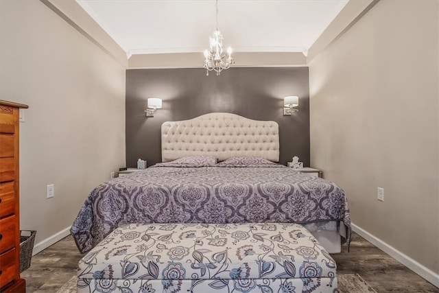 bedroom featuring ornamental molding, an inviting chandelier, and dark hardwood / wood-style floors