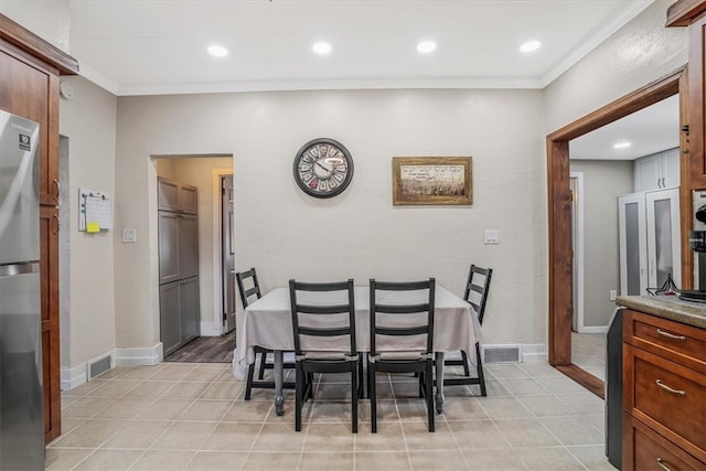 tiled dining area with crown molding