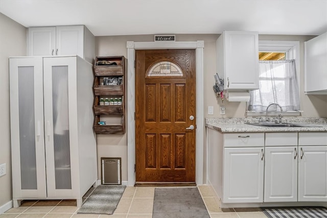 tiled entrance foyer with sink