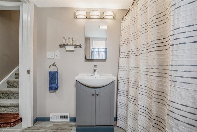 bathroom with vanity and hardwood / wood-style floors