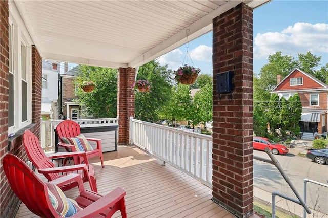 wooden terrace featuring covered porch