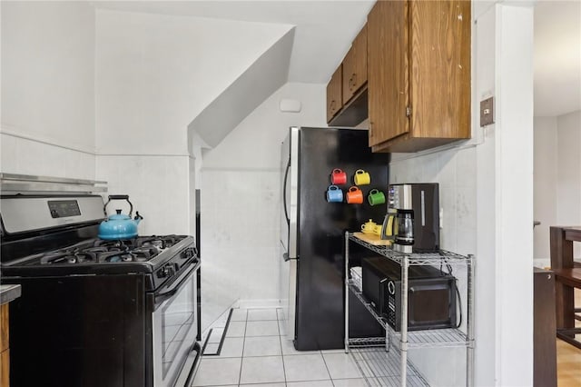 kitchen with stainless steel appliances and light tile patterned flooring