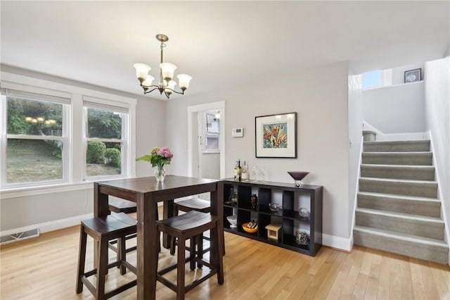 dining room featuring a chandelier and hardwood / wood-style floors