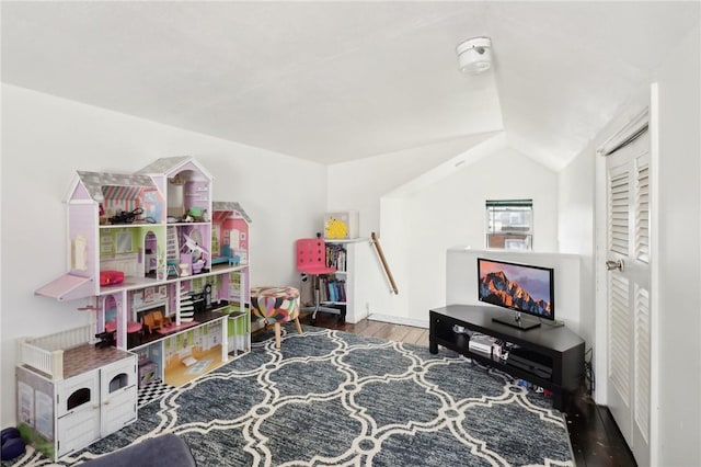 recreation room with dark hardwood / wood-style flooring and lofted ceiling