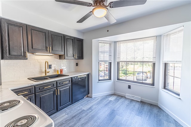 kitchen with ceiling fan, decorative backsplash, sink, black dishwasher, and light hardwood / wood-style floors