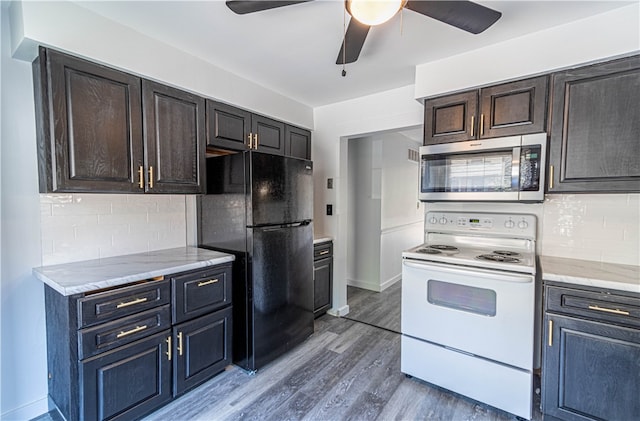 kitchen featuring black fridge, white electric stove, tasteful backsplash, and ceiling fan