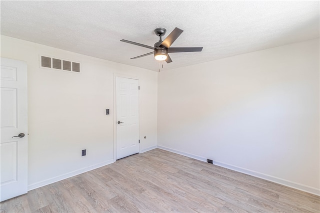 spare room with light hardwood / wood-style flooring, a textured ceiling, and ceiling fan