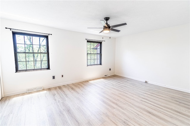 unfurnished room with ceiling fan and light wood-type flooring