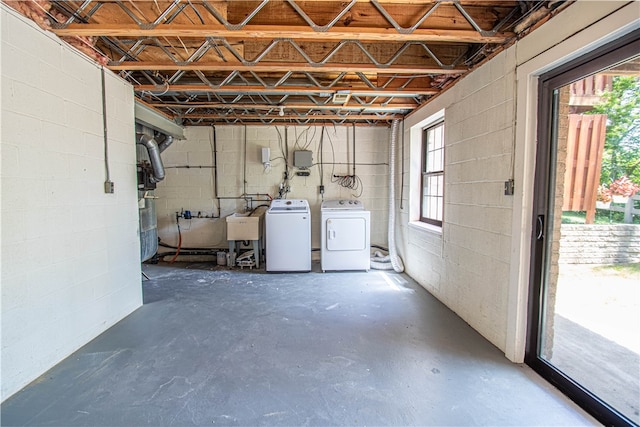 basement featuring washer and dryer, sink, and plenty of natural light