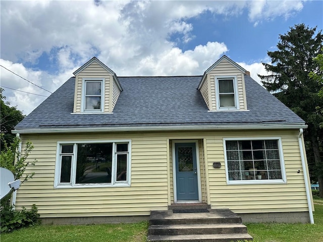 new england style home featuring a shingled roof