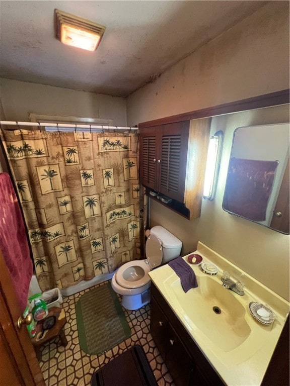 bathroom featuring tile patterned floors, toilet, and vanity