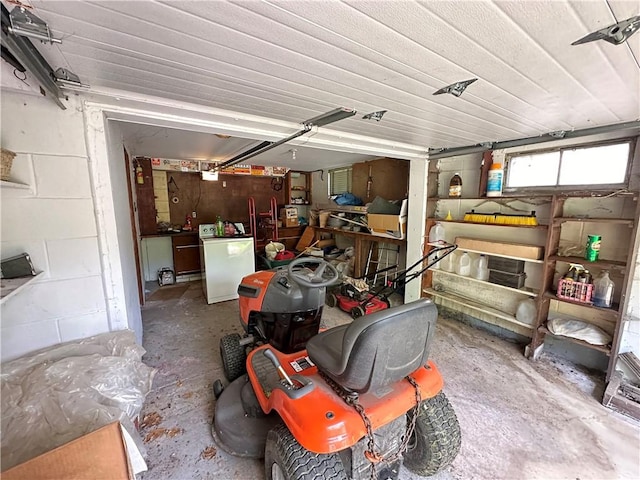 garage featuring concrete block wall and washer / clothes dryer