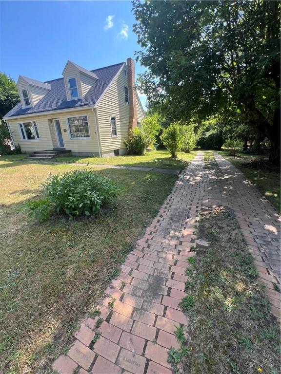 view of side of home with a lawn