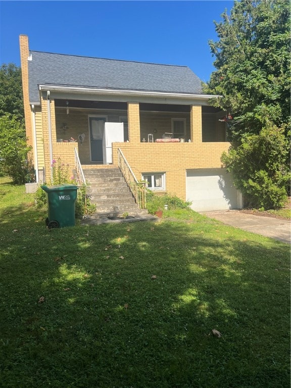 view of front of home with a garage and a front yard