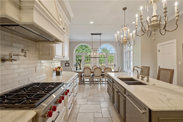 kitchen with sink, an island with sink, stainless steel appliances, custom exhaust hood, and decorative backsplash